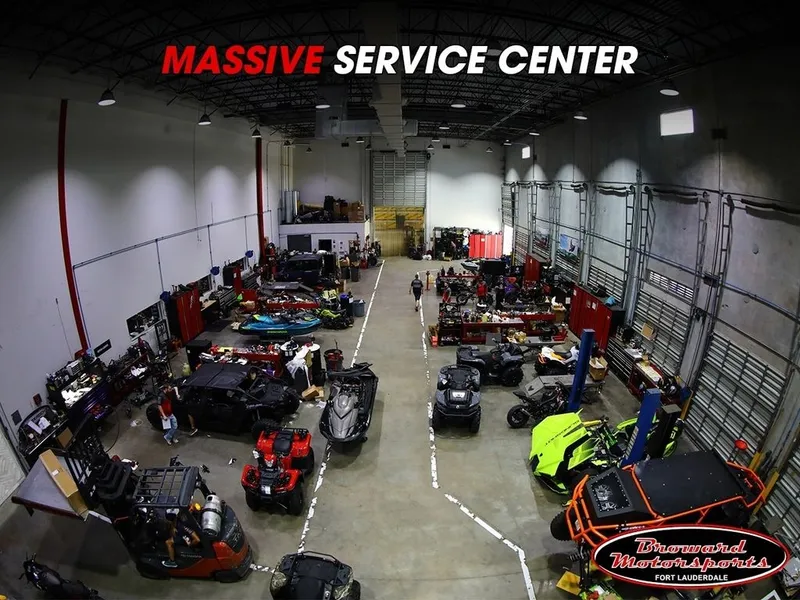 Slide: The Image of Interior of a large service center with various vehicles, including jet skis and ATVs. - 4