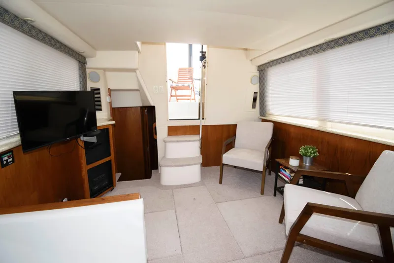 Slide: The Image of Interior of 2000 Carver 356 Aft Cabin Yacht with cozy seating area. - 14