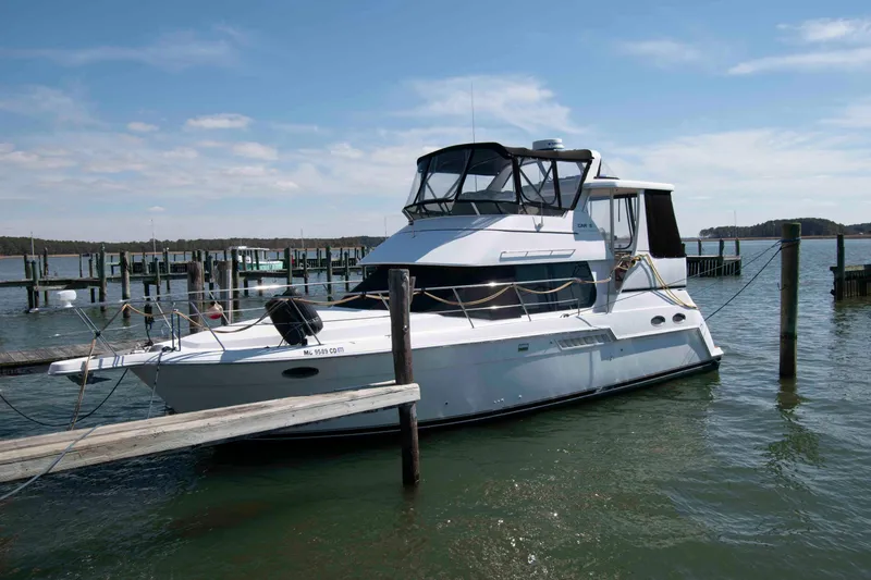 The Image of 2000 Carver 356 Aft Cabin Motor Yacht docked at a marina under clear skies. - 0
