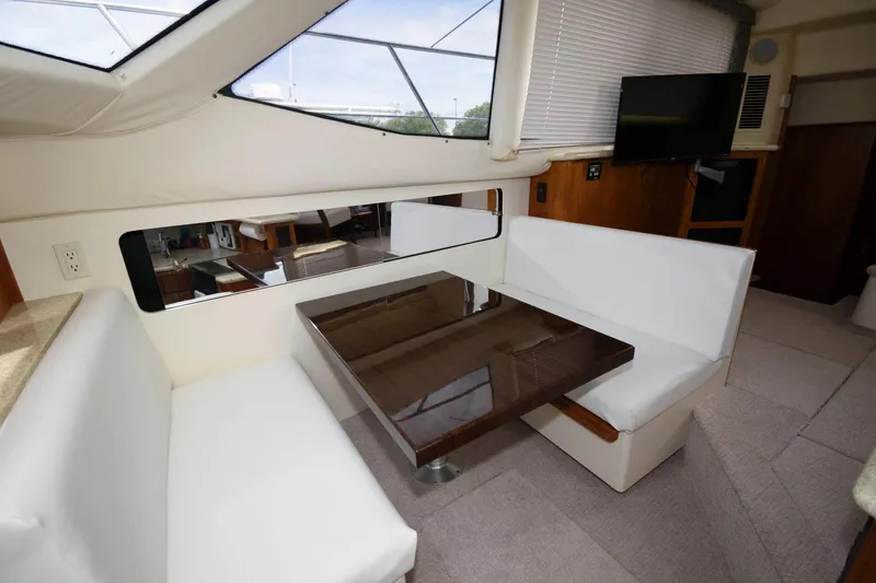 Slide: The Image of Compact kitchen in 2000 Carver 356 Aft Cabin Motor Yacht with appliances and wood cabinetry. - 16