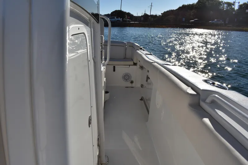 Slide: The Image of 2020 Sea Hunt Ultra 255 SE boat deck with sparkling water view. - 12