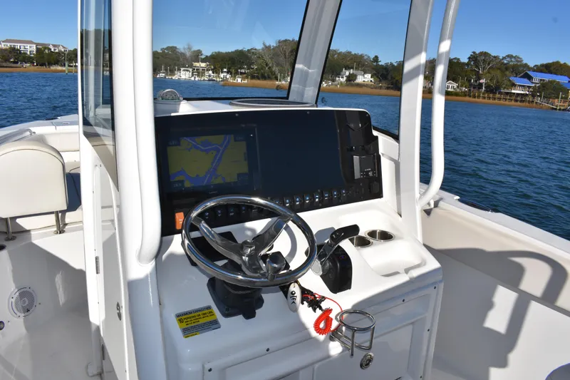 Slide: The Image of 2020 Sea Hunt Ultra 255 SE boat dashboard with navigation system on a sunny day. - 13