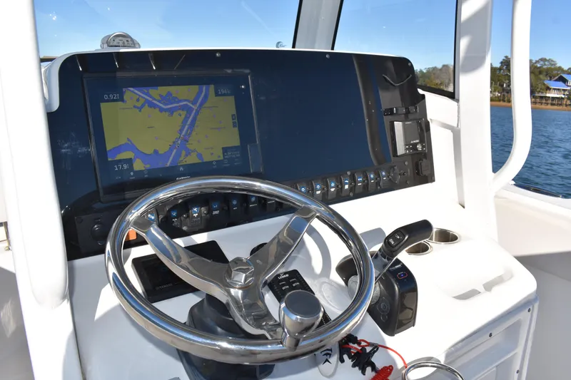 Slide: The Image of 2020 Sea Hunt Ultra 255 SE helm with navigation display and steering wheel. - 14