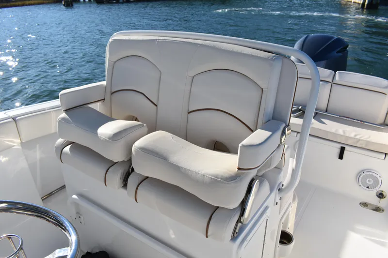 Slide: The Image of 2020 Sea Hunt Ultra 255 SE boat seating with armrests on calm water. - 15