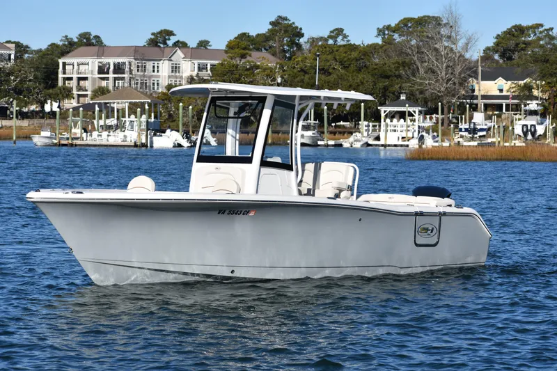 Slide: The Image of 2020 Sea Hunt Ultra 255 SE boat on calm water near marina. - 2