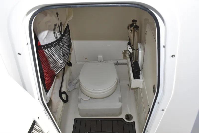 Slide: The Image of 2020 Sea Hunt Ultra 255 SE boat interior with compact marine toilet. - 20