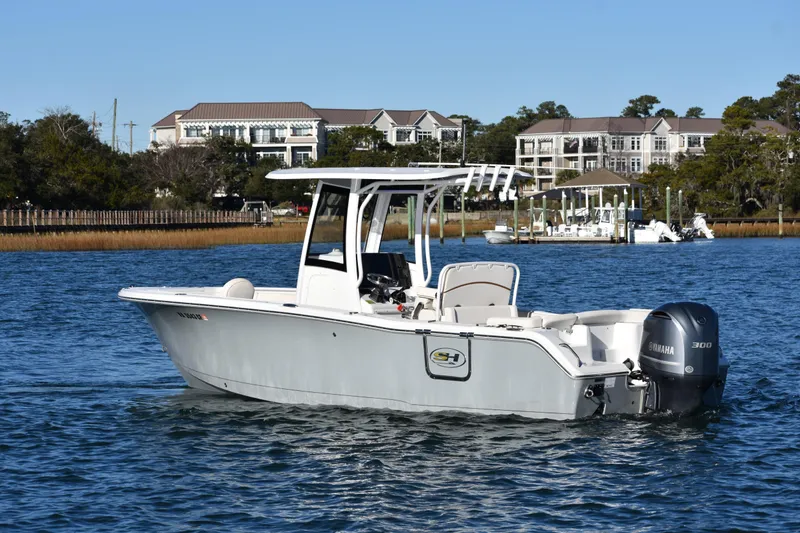 Slide: The Image of 2020 Sea Hunt Ultra 255 SE boat on calm water near residential area. - 4