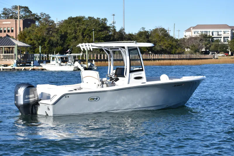 Slide: The Image of 2020 Sea Hunt Ultra 255 SE boat on water with Yamaha engine, near dock. - 6
