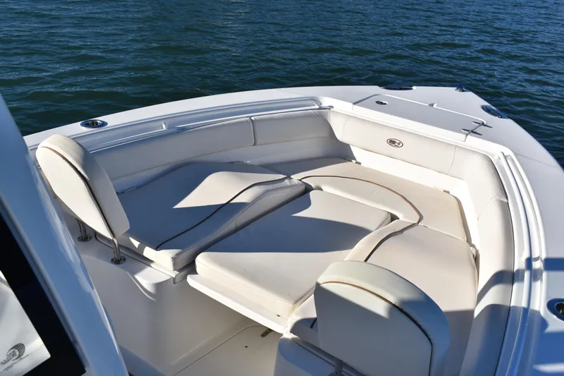 Slide: The Image of 2020 Sea Hunt Ultra 255 SE boat interior with cushioned seating on water. - 8