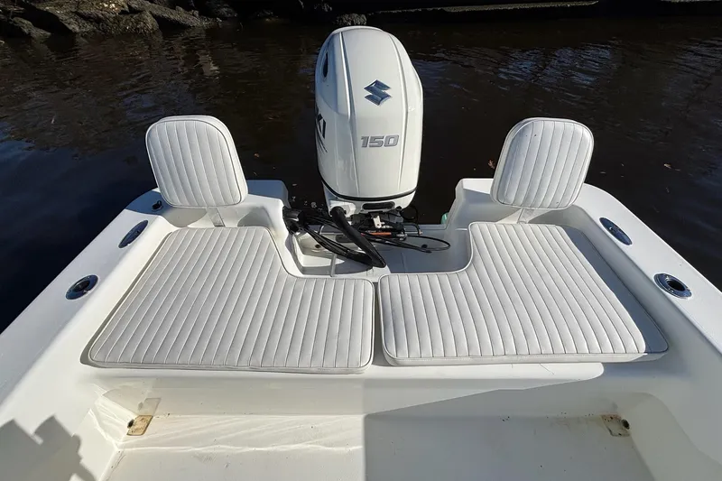 Slide: The Image of 2021 Savannah SS21 boat with Suzuki 150 engine, featuring white cushioned seating. - 10