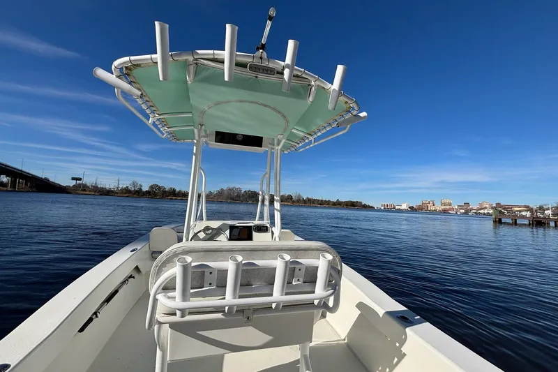 Slide: The Image of Savannah SS21 boat on calm water, clear blue sky, cityscape in background, 2021 model. - 11