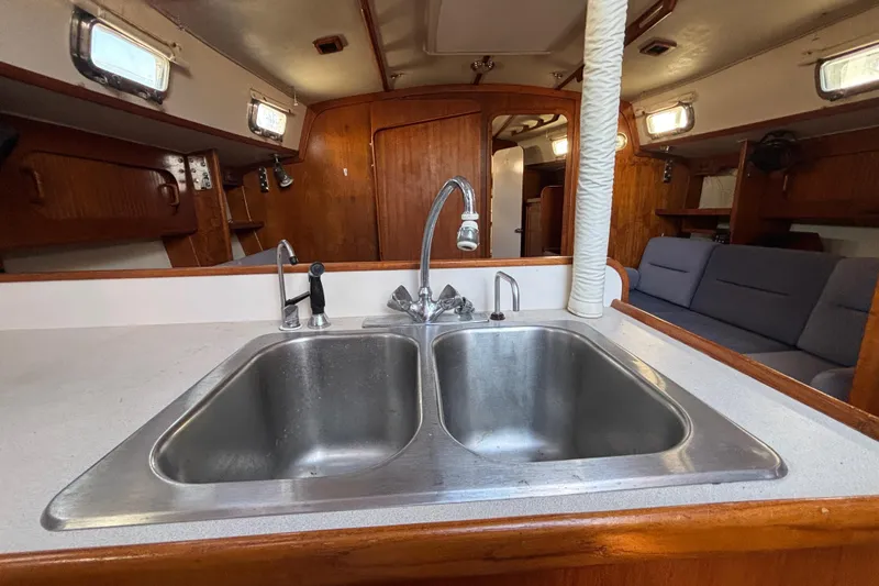 Slide: The Image of Interior of 1997 Caliber 40LRC sailboat with dual sink and cozy seating area. - 16