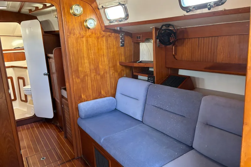 Slide: The Image of Interior of 1997 Caliber 40LRC sailboat with wooden paneling and blue seating. - 18
