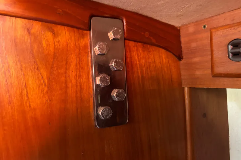 Slide: The Image of Interior view of 1997 Caliber 40LRC sailboat with metal bolts on wooden panel. - 19