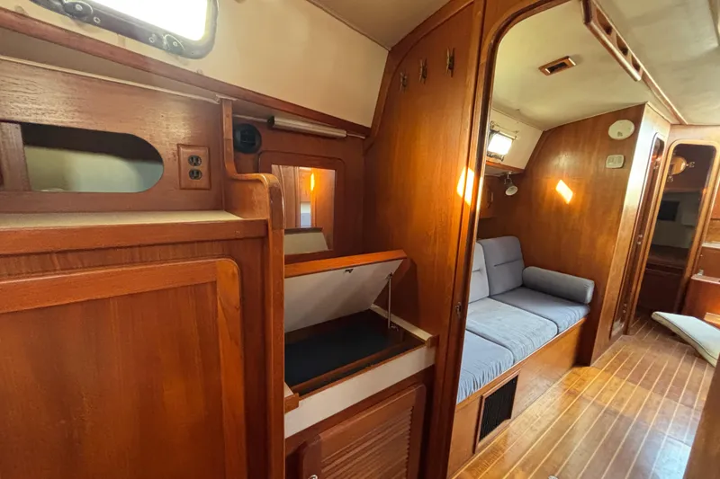 Slide: The Image of Interior of 1997 Caliber 40LRC sailboat with wooden finish and cozy seating area. - 24