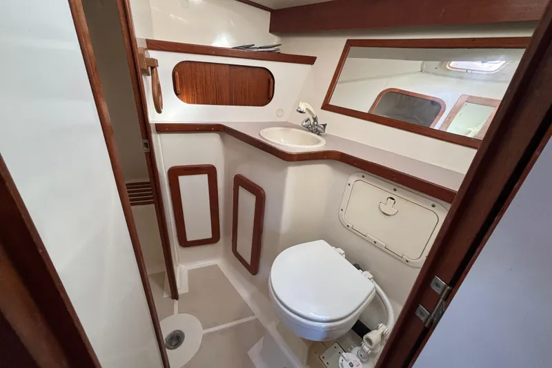 Slide: The Image of 1997 Caliber 40LRC yacht bathroom with sink, toilet, and wooden accents. - 25