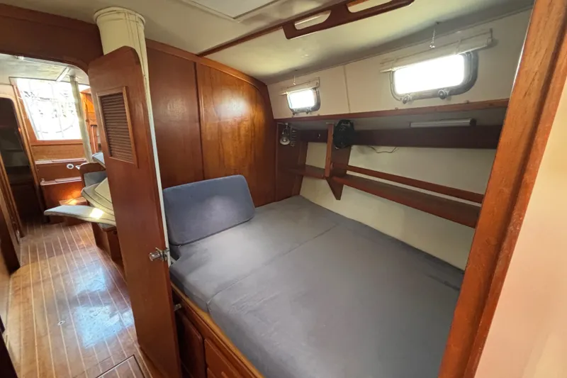 Slide: The Image of Cozy cabin interior of 1997 Caliber 40LRC sailboat with wooden furnishings and bed. - 28