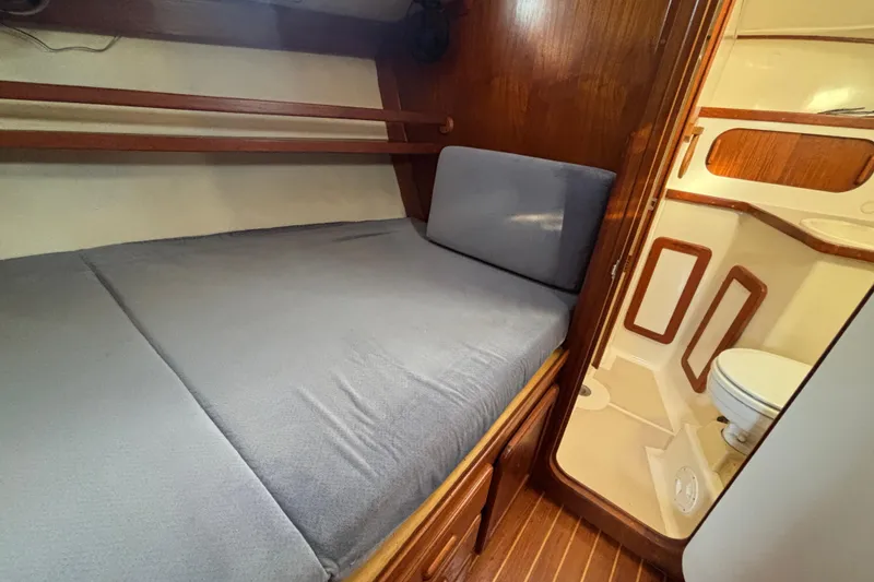 Slide: The Image of Cozy cabin interior of 1997 Caliber 40LRC yacht with bed and adjacent bathroom. - 29