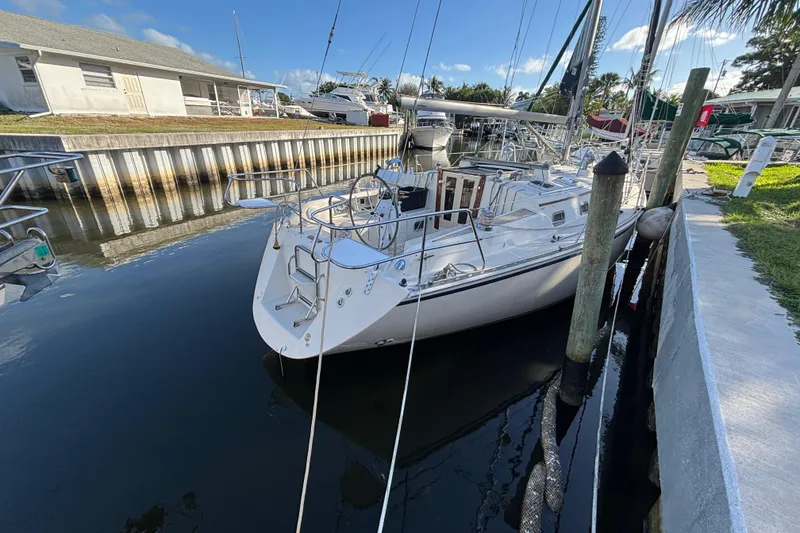 Slide: The Image of 1997 Caliber 40LRC sailboat docked in a marina under a clear blue sky. - 33