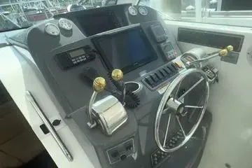 Slide: The Image of 2007 Tiara Yachts 3000 Open docked, showcasing sleek design and windshield wipers. - 11