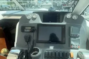 Slide: The Image of 2007 Tiara Yachts 3000 Open cabin entrance with helm controls and seating. - 12