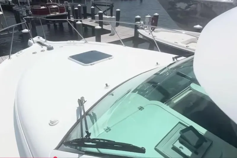 Slide: The Image of 2007 Tiara Yachts 3000 Open galley with sink, stove, microwave, and wooden cabinetry. - 15