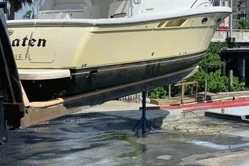 Slide: The Image of 2007 Tiara Yachts 3000 Open on a lift at a marina dock. - 3