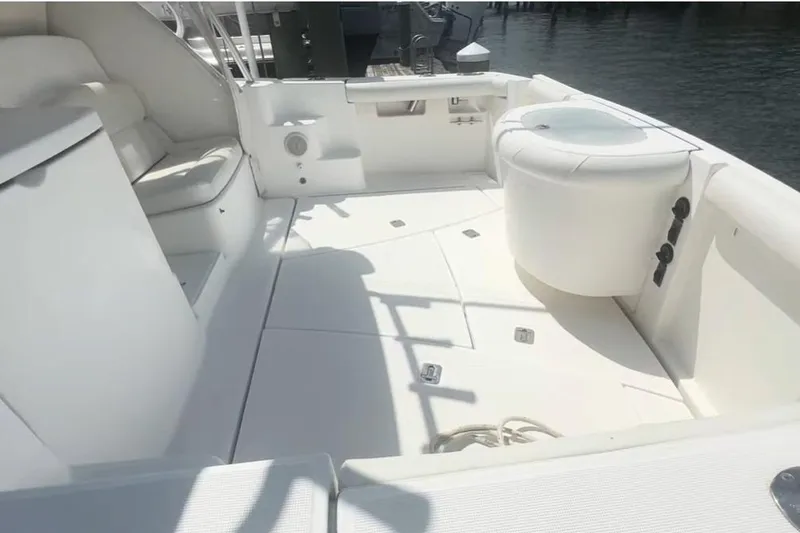 Slide: The Image of 2007 Tiara Yachts 3000 Open boat deck with seating and storage, docked by water. - 6