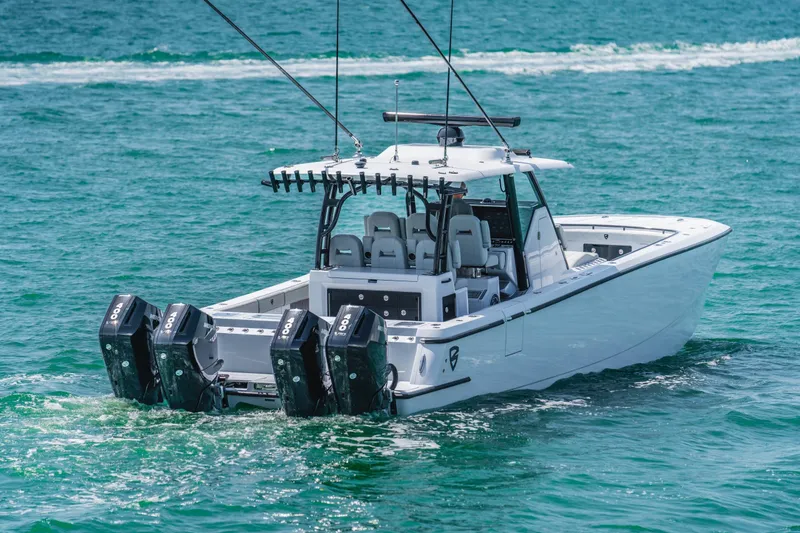 Slide: The Image of 2026 Barker Boatworks 40HPC with quad engines cruising on clear blue water. - 10