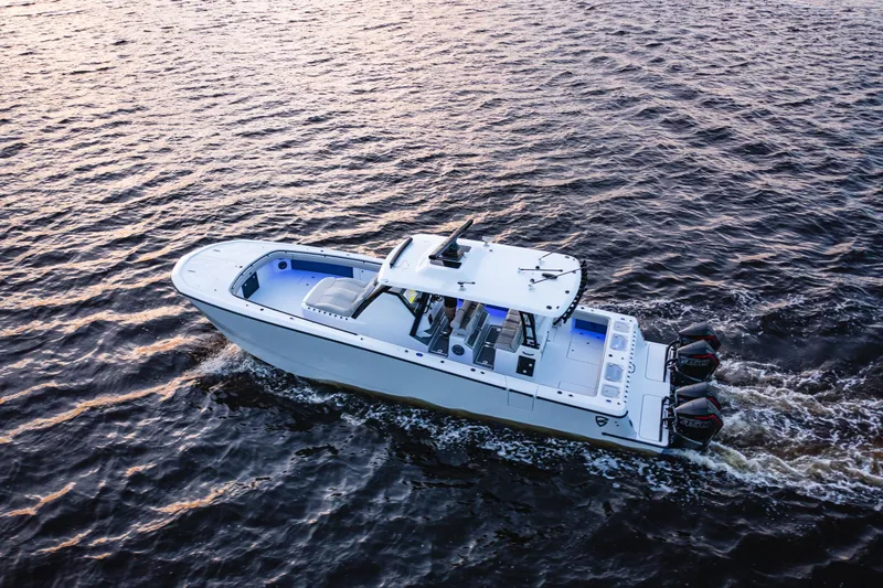 Slide: The Image of 2026 Barker Boatworks 40HPC cruising on open water at sunset. - 13