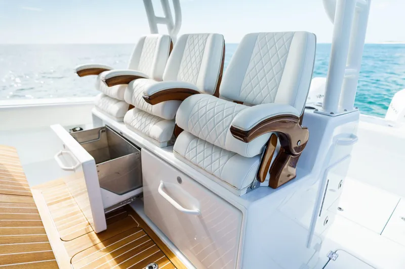 Slide: The Image of Luxurious seating on 2026 Barker Boatworks 40HPC, featuring elegant white upholstery and ocean backdrop. - 25