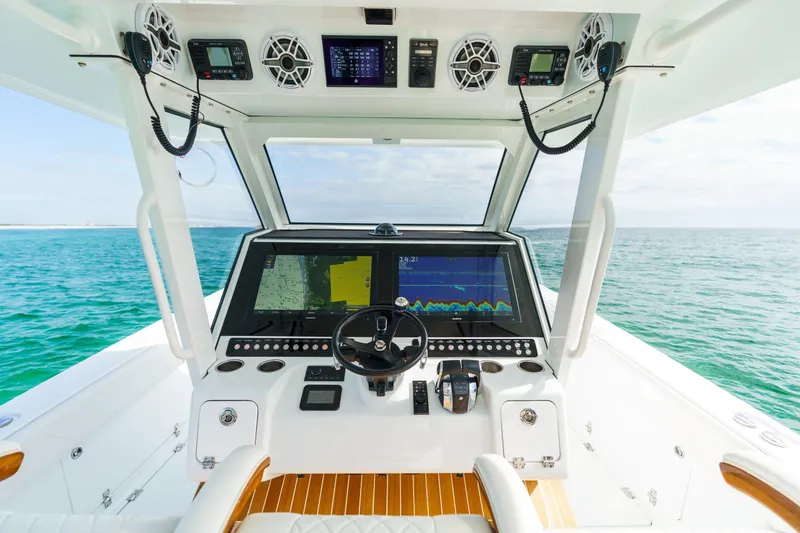Slide: The Image of 2026 Barker Boatworks 40HPC helm with advanced navigation system on open water. - 27
