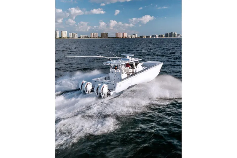Slide: The Image of 2026 Barker Boatworks 40HPC cruising on open water with city skyline backdrop. - 28