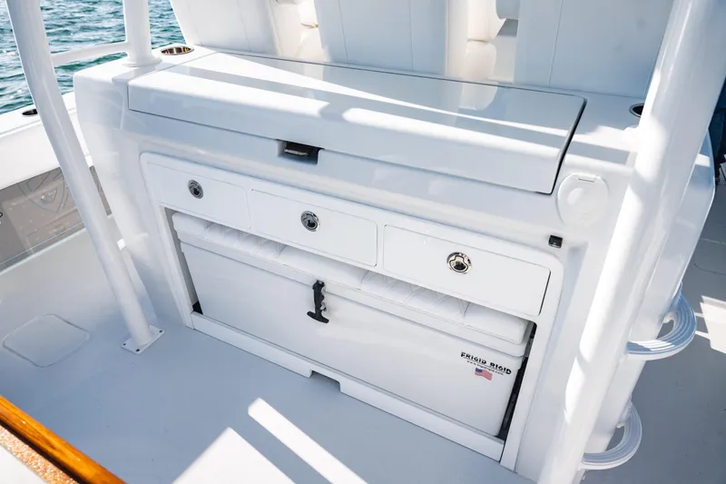 Slide: The Image of 2026 Barker Boatworks 40HPC interior with storage compartments and Frigid Rigid cooler. - 31