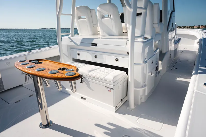Slide: The Image of 2026 Barker Boatworks 40HPC interior with seating, wooden table, and ocean view. - 33