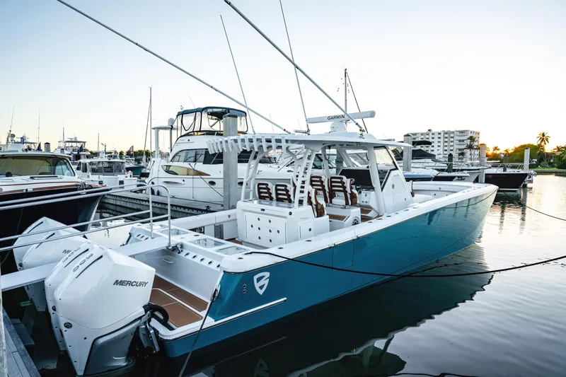 Slide: The Image of 2026 Barker Boatworks 40HPC docked, featuring sleek design and powerful Mercury engines. - 40