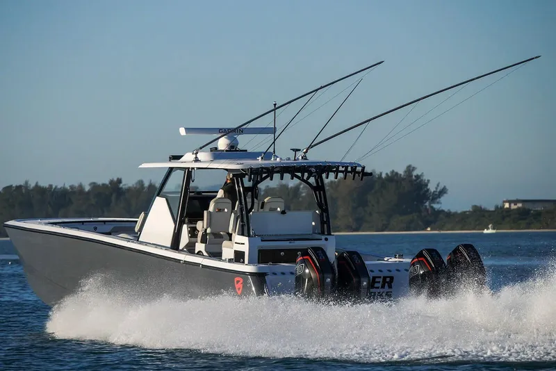 Slide: The Image of 2026 Barker Boatworks 40HPC cruising on water with powerful engines and fishing rods. - 43