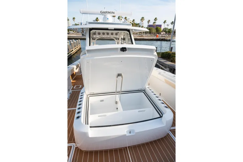 Slide: The Image of 2026 Barker Boatworks 40HPC open storage compartment on deck, docked by water. - 47