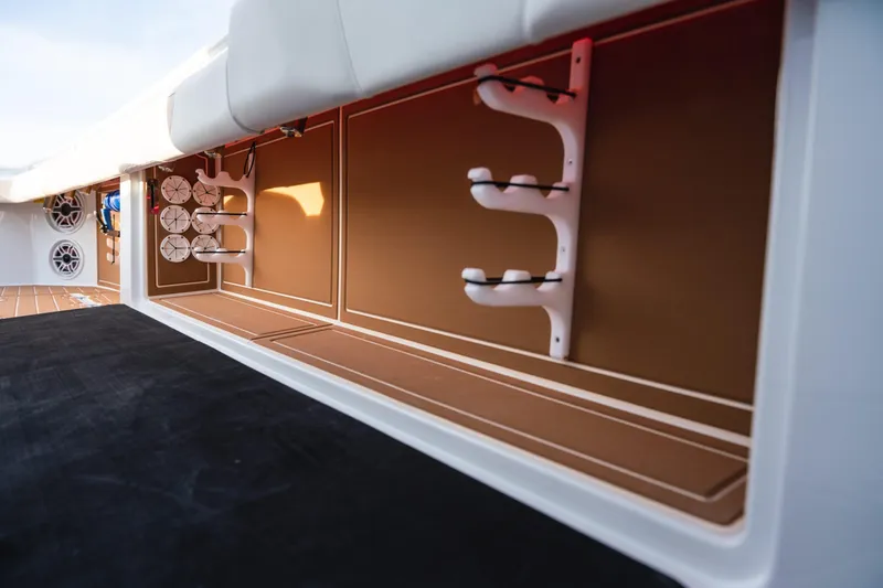 Slide: The Image of 2026 Barker Boatworks 40HPC interior storage with rod holders and speakers. - 49