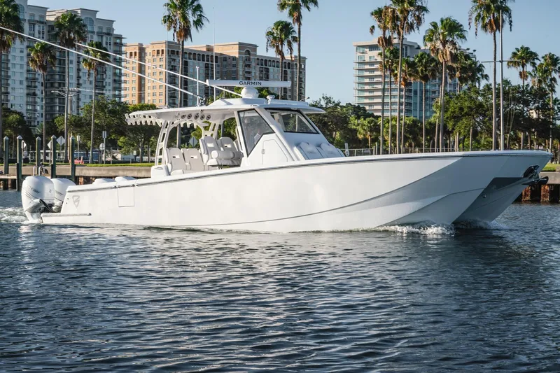 Slide: The Image of 2026 Barker Boatworks 40HPC cruising on water with cityscape and palm trees in background. - 6