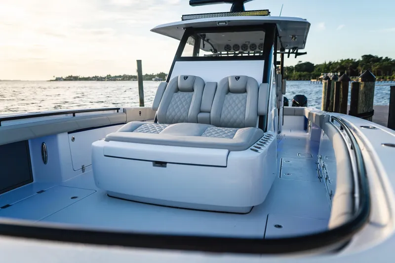 Slide: The Image of 2026 Barker Boatworks 40HPC luxury seating, docked by the water at sunset. - 14