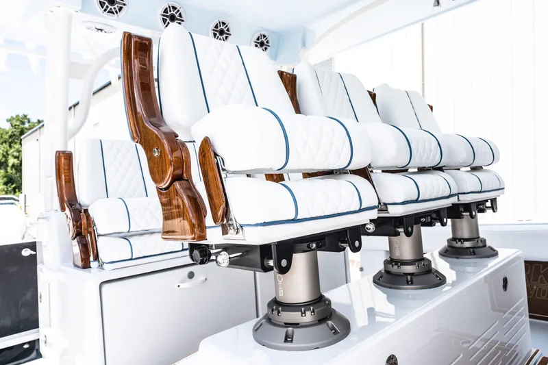 Slide: The Image of Luxury seating on 2026 Barker Boatworks 40HPC, featuring white cushions and wooden accents. - 16