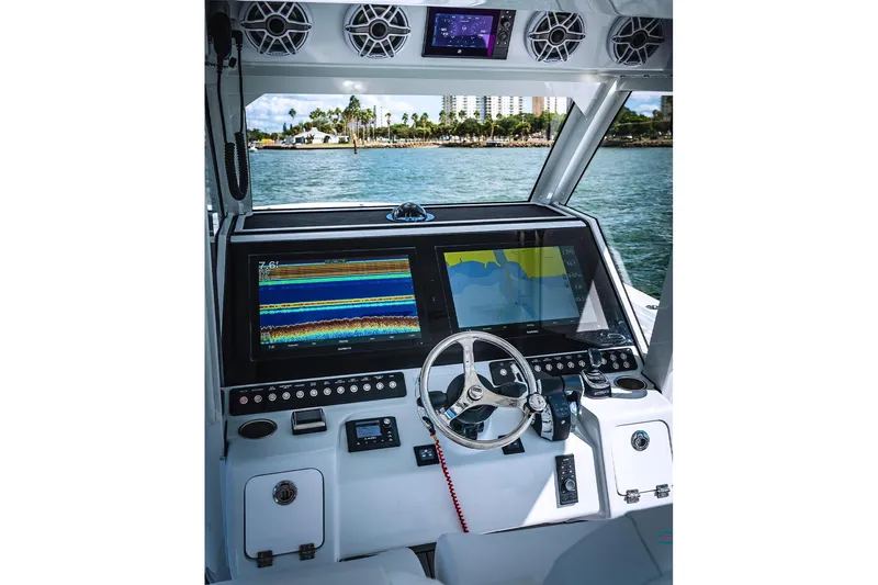Slide: The Image of 2026 Barker Boatworks 40HPC helm with advanced navigation displays and controls. - 29