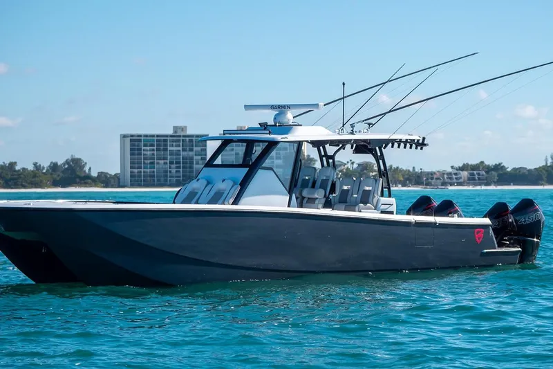 Slide: The Image of 2026 Barker Boatworks 40HPC on clear blue water, featuring sleek design and powerful engines. - 44