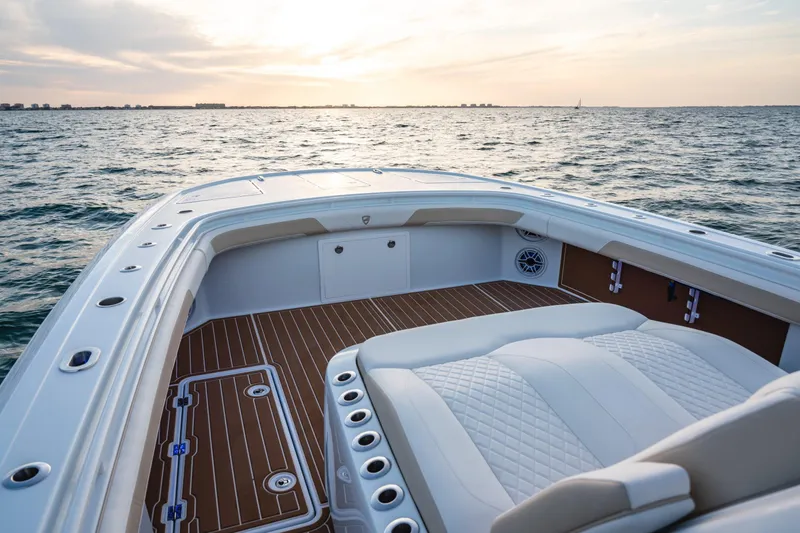 Slide: The Image of 2026 Barker Boatworks 40HPC on water, featuring luxurious seating and elegant deck design. - 53