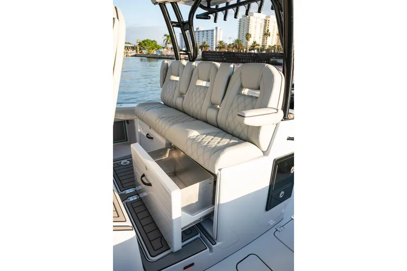 Slide: The Image of 2026 Barker Boatworks 40HPC interior seating with storage drawer, dockside view. - 55