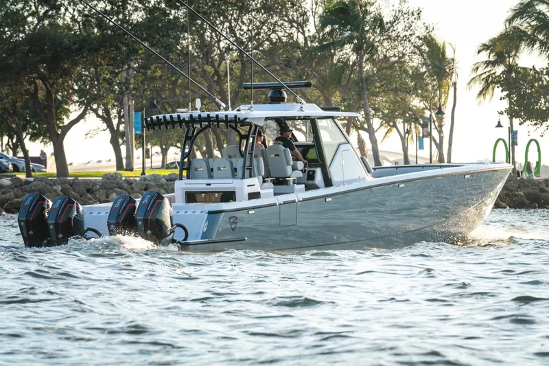 Slide: The Image of 2026 Barker Boatworks 40HPC cruising on water with triple outboard engines. - 58
