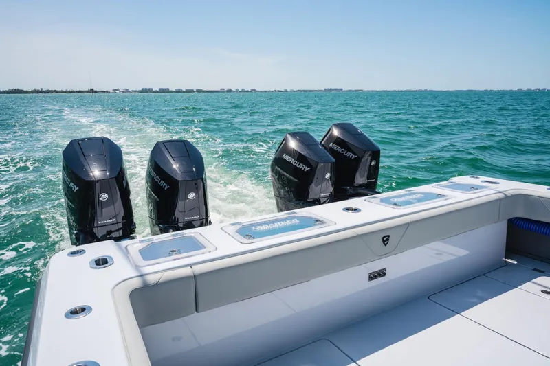 Slide: The Image of 2026 Barker Boatworks 40HPC with four Mercury engines cruising on open water. - 7