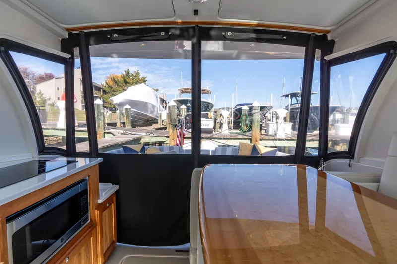 Slide: The Image of Interior view of 2023 Back Cove 340 yacht with marina backdrop. - 11