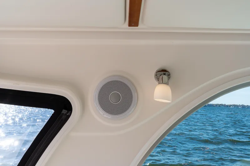 Slide: The Image of Interior of 2023 Back Cove 340 boat with speaker and light fixture, overlooking water. - 13